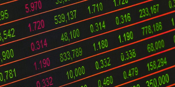 Close-up of a digital stock market data display showing colorful financial numbers and trends.