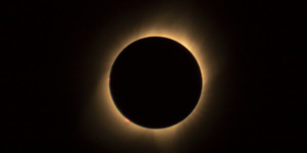 A captivating view of a solar eclipse highlighting the glowing corona in a dark sky.